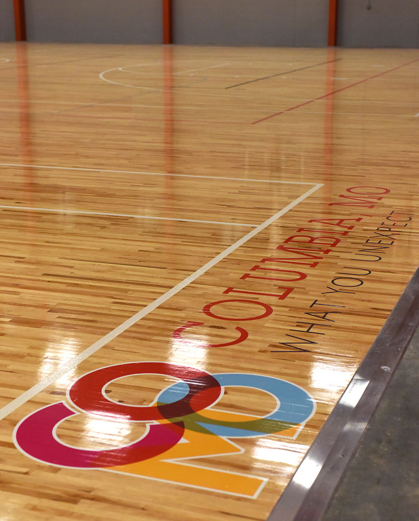 The City of Columbia logo shines on the court floor during a dedication ceremony for the new Columbia Sports Fieldhouse Thursday